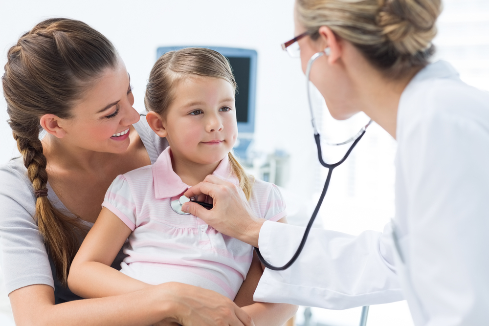 Mother with girl being examined by female pediatrician in clinic-1