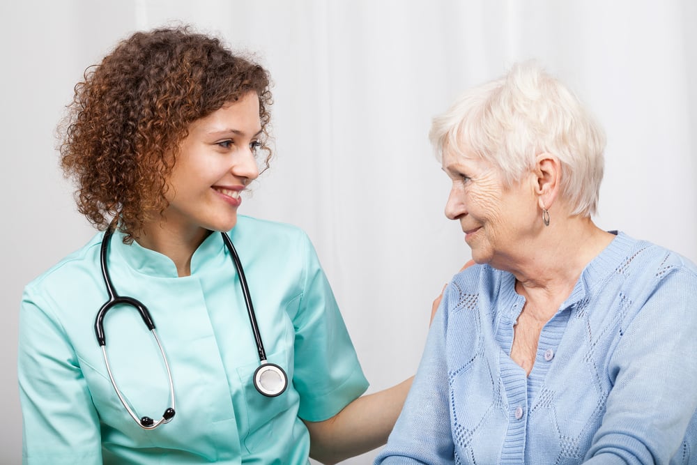 Smiling nurse and happy elderly lady, horizontal-3